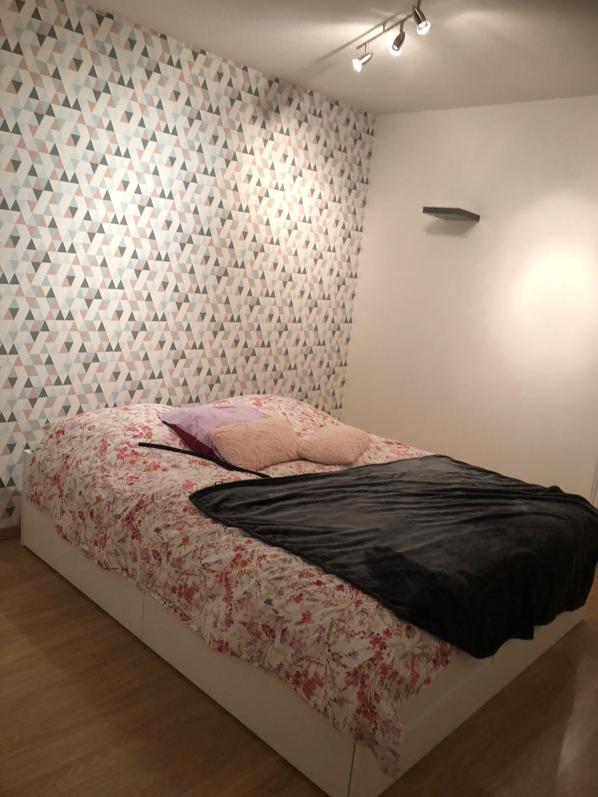 Bedroom with a decorative wallpaper